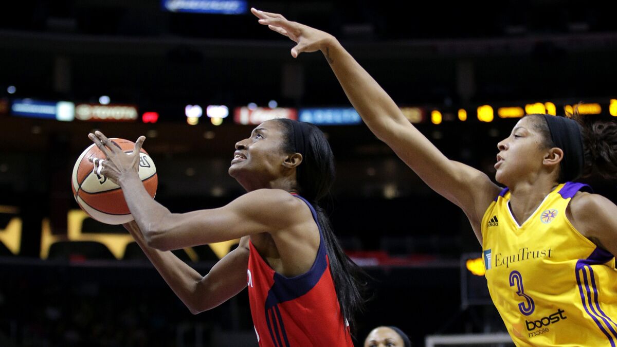 Sparks forward Candace Parker tries to block a shot by Mystics forward LaToya Sanders in the first half Thursday night at Staples Center.