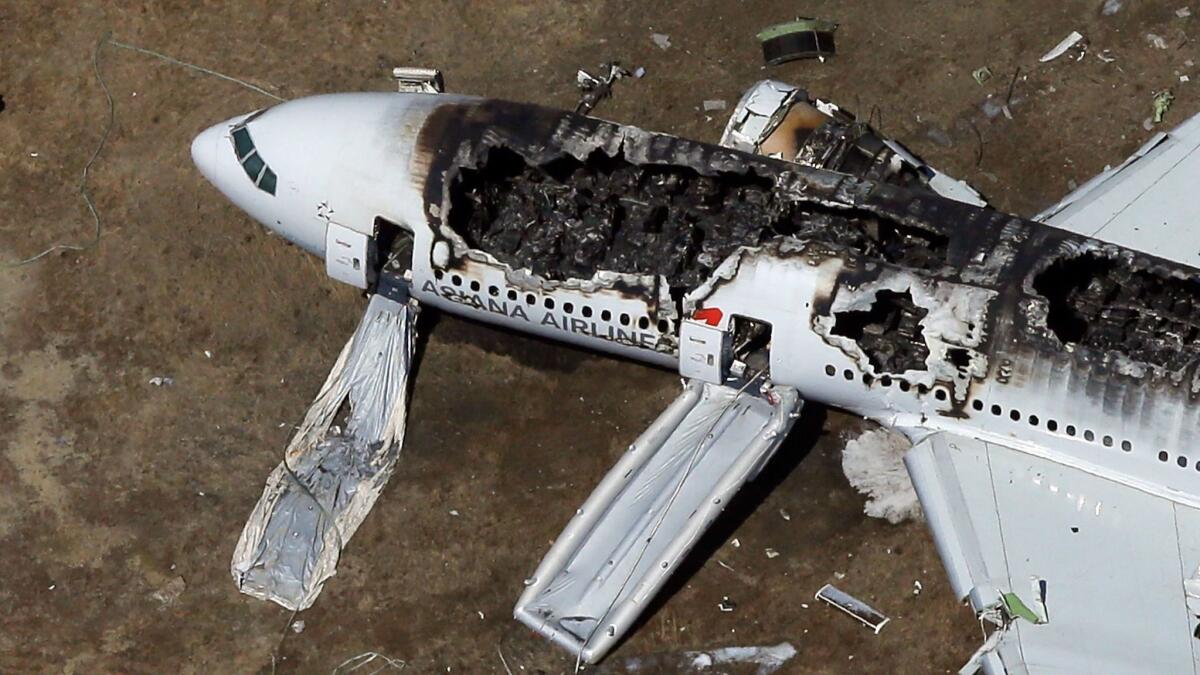 An Asiana Airlines Boeing 777 lies burned near the runway after it crash-landed at San Francisco International Airport in 2013.