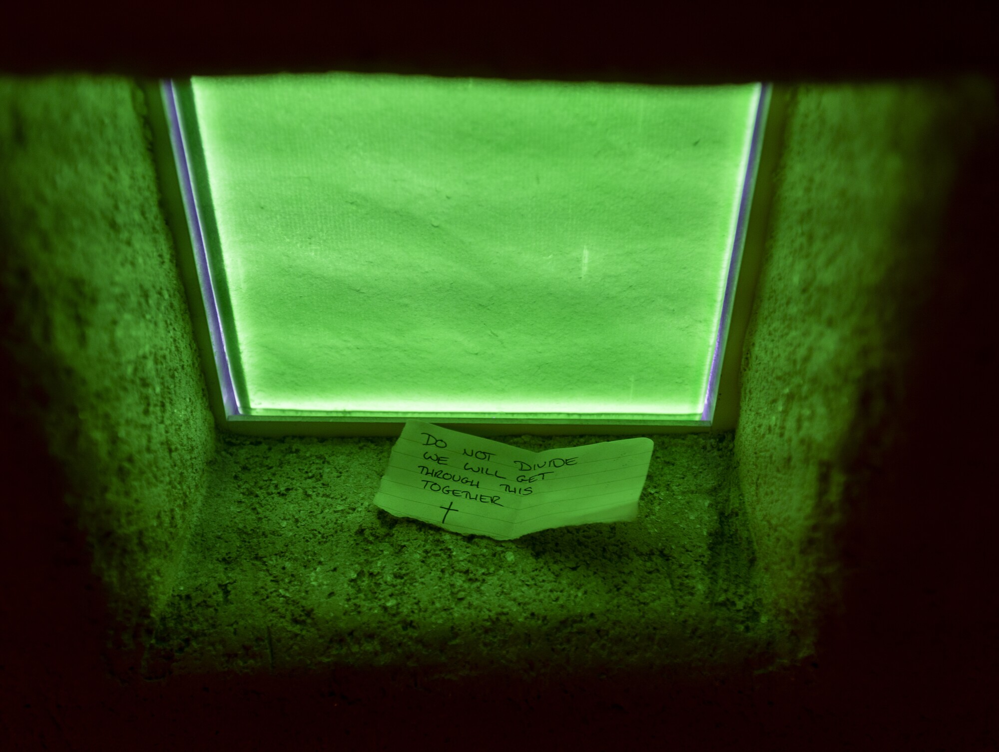 A prayer note in a window box.