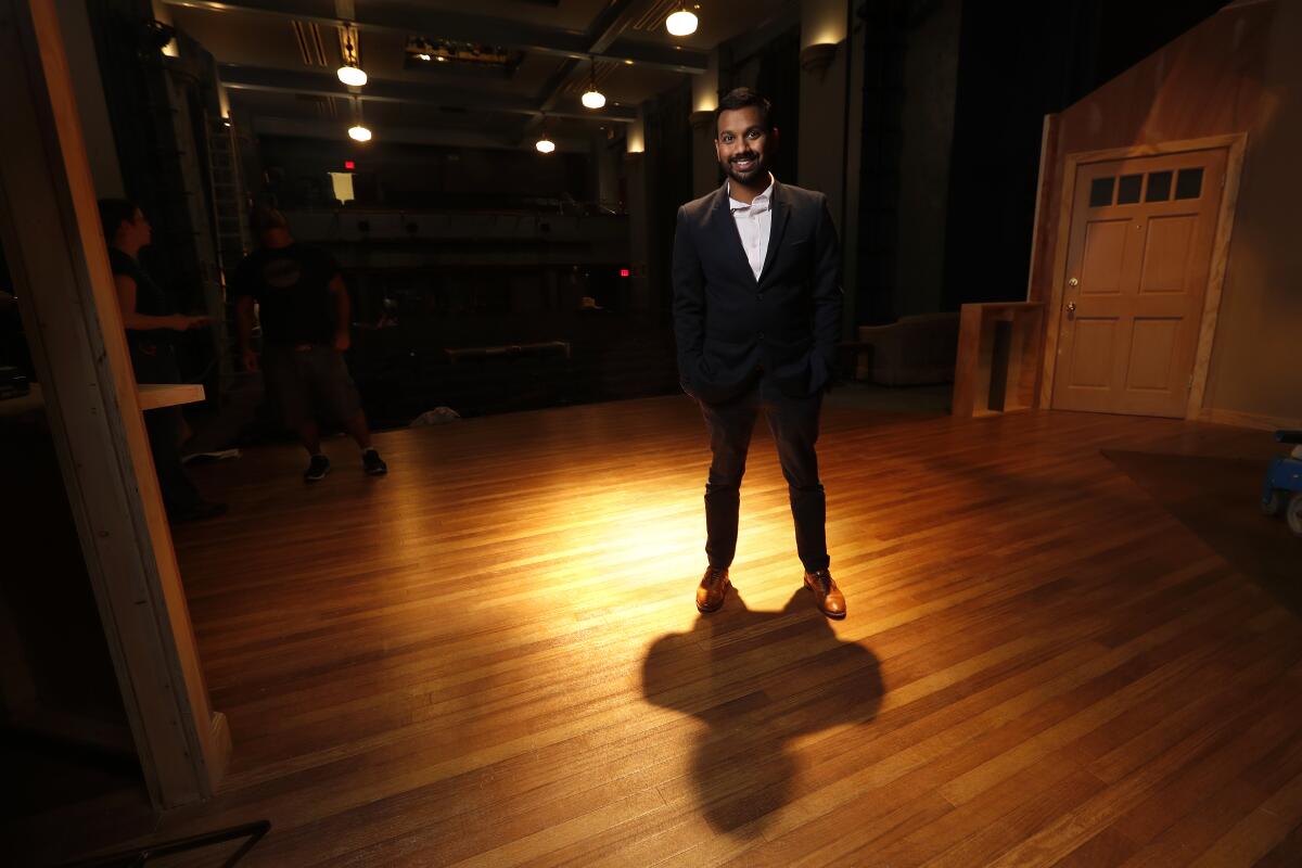 Snehal Desai, artistic director of East West Players, photographed on an empty stage.