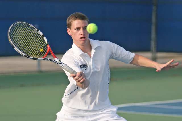 Corona del Mar's Daniel Anastos hits a shot during Thursday's Battle of the Bay tennis match between Corona del Mar and Newport Harbor.