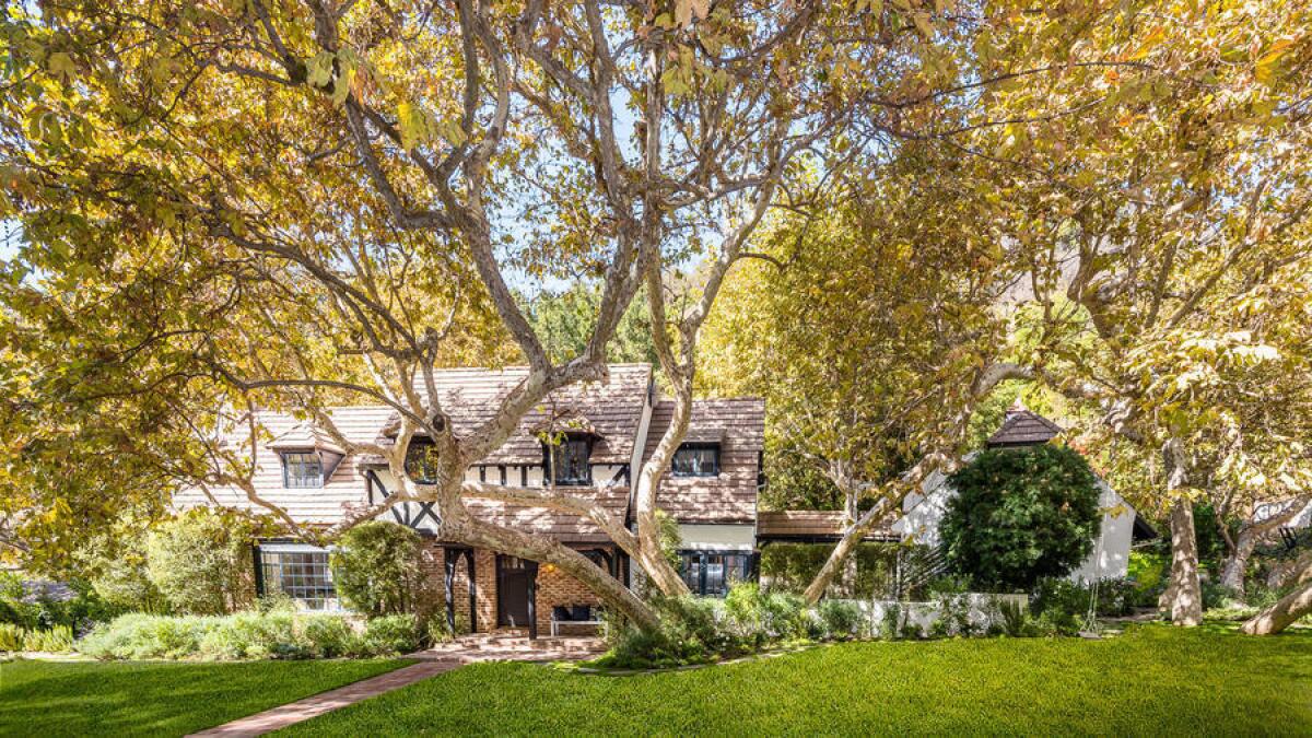 The Brittany Tudor-style home, designed by noted architect Gerard Colcord, sits on a lush, three-quarter-acre lot in Mandeville Canyon.