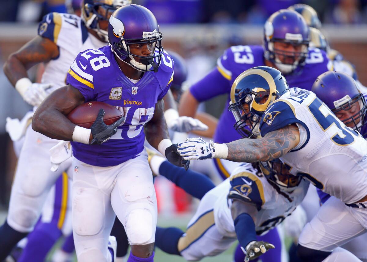 Minnesota Vikings running back Adrian Peterson runs the ball against the St. Louis Rams during a game on Nov. 8.