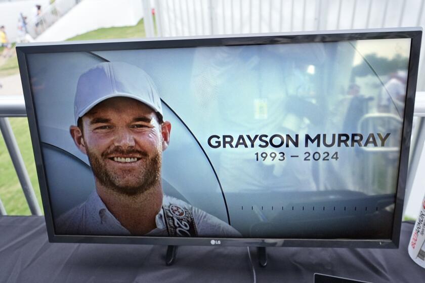 A golf television broadcast is played at the broadcast tent showing a photo of Grayson Murray during the third round of the Charles Schwab Challenge golf tournament at Colonial Country Club in Fort Worth, Texas, Saturday, May 25, 2024. Two-time PGA Tour winner Murray died Saturday morning at age 30, one day after he withdrew from the tournament. (AP Photo/LM Otero)