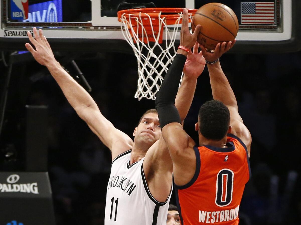 Nets center Brook Lopez (11) defends a shot by Thunder guard Russell Westbrook (0) during the second half.