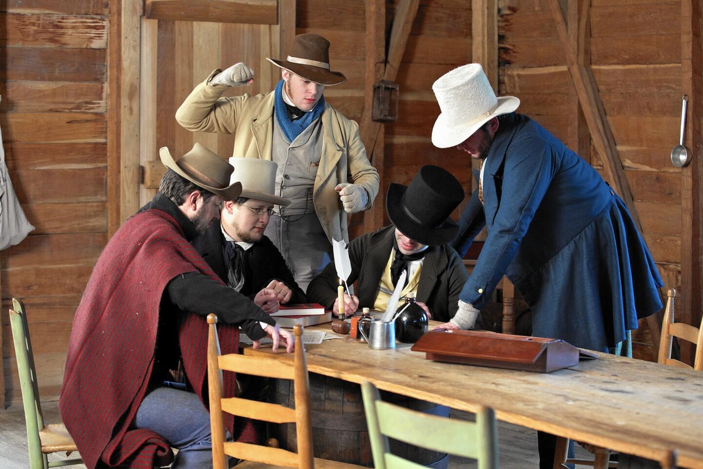 Men in period costume re-enact the signing of the Texas Declaration of Independence during a special ceremony.