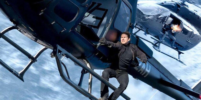 Tom Cruise hangs from a helicopter in a climactic action sequence in 