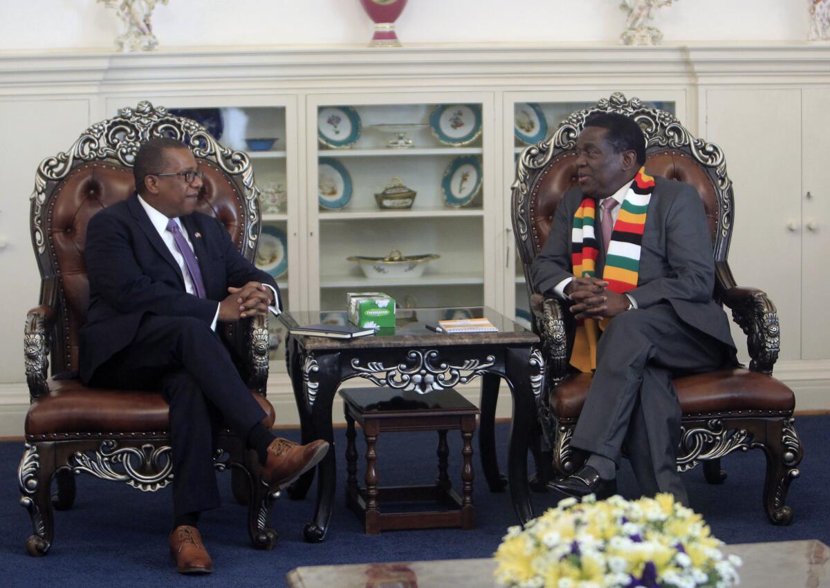 U.S. Ambassador to Zimbabwe Brian A. Nichols, left, speaks with Zimbabwean President-elect Emmerson Mnangagwa in 2018. 