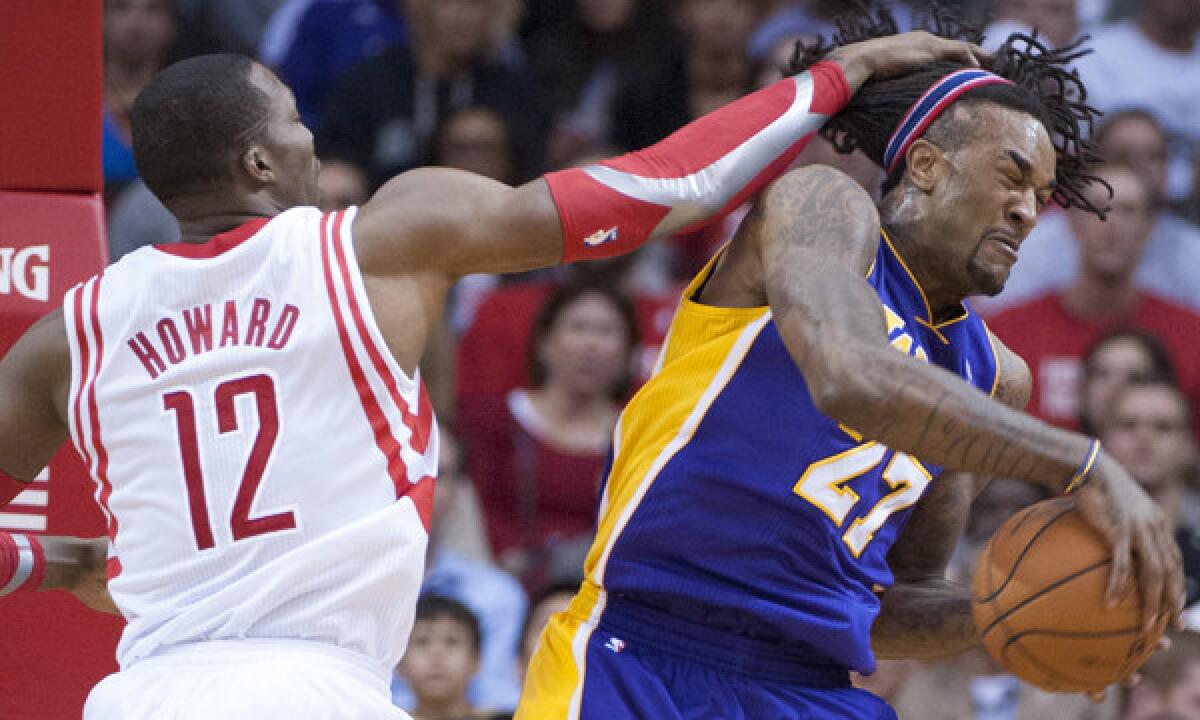 Lakers power forward Jordan Hill (27) pulls down a rebound in front of Rockets center Dwight Howard during the Lakers' 99-98 win in Houston last November.