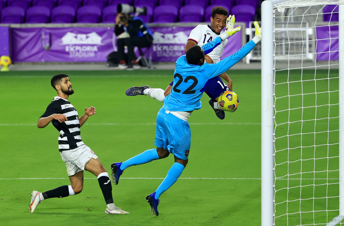 Trinidad and Tobago goalkeeper Adrian Foncette stops a shot from U.S. forward Jonathan Lewis.