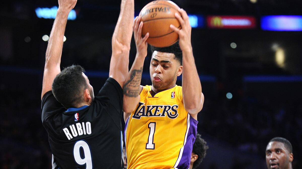 Lakers point guard D'Angelo Russell drives against Timberwolves point guard Ricky Rubio in the third quarter on Wednesday night at Staples Center.