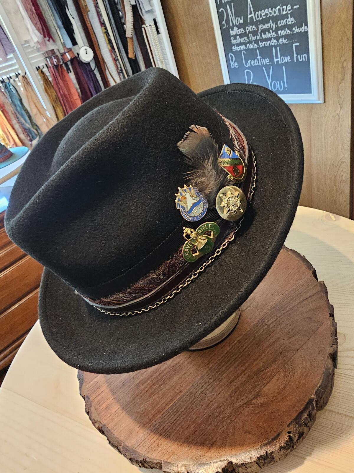 Tara Holsapple took inspiration from photographer John Hancock's collection of old military pins and used them in his hat.