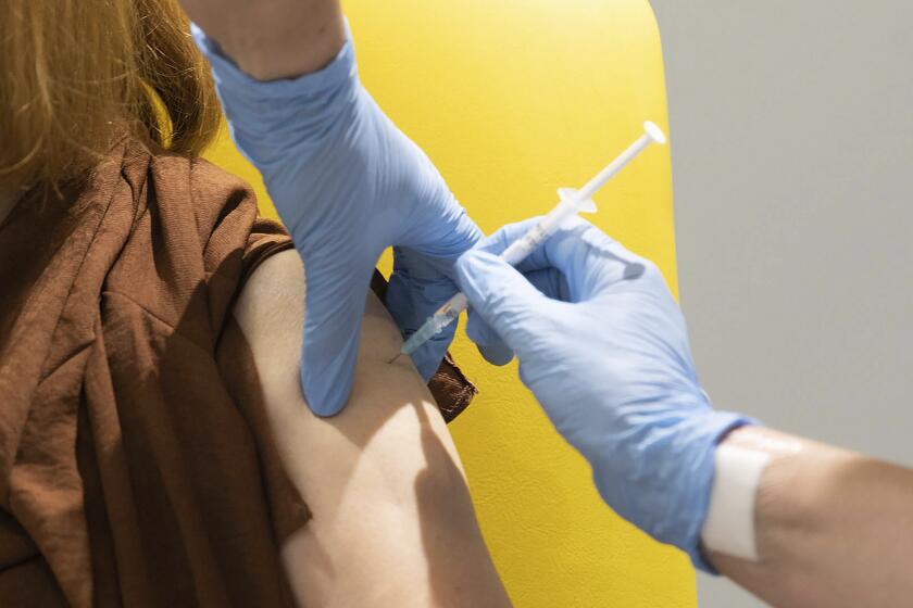 A volunteer receives a dose of the coronavirus vaccine developed by AstraZeneca and Oxford University.
