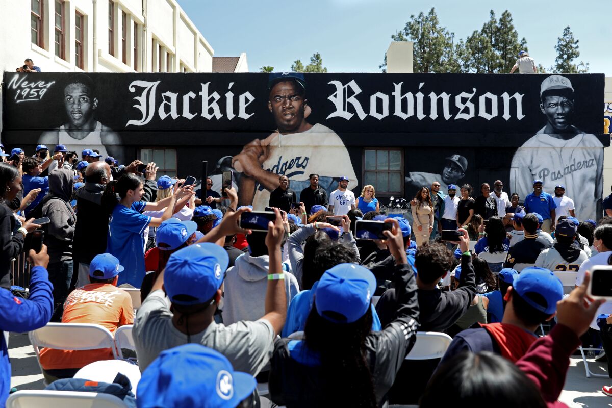 Students, faculty and special guests attend a Jackie Robinson mural tribute held at John Muir High School in Pasadena.