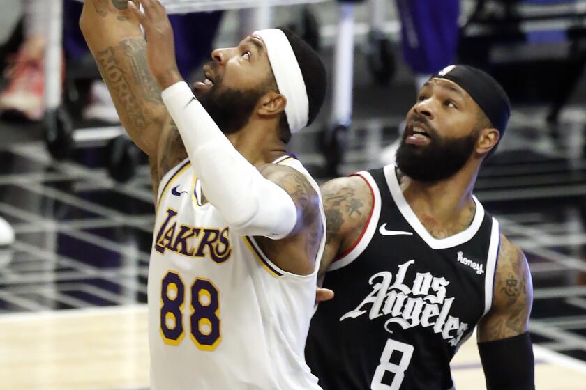 Twins Markieff Morris of the Lakers and Marcus Morris Sr. of the Clippers battle for a loose ball.