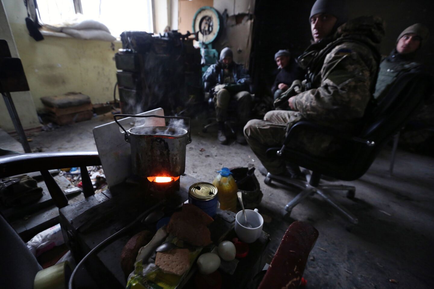 Troops cook a meal.