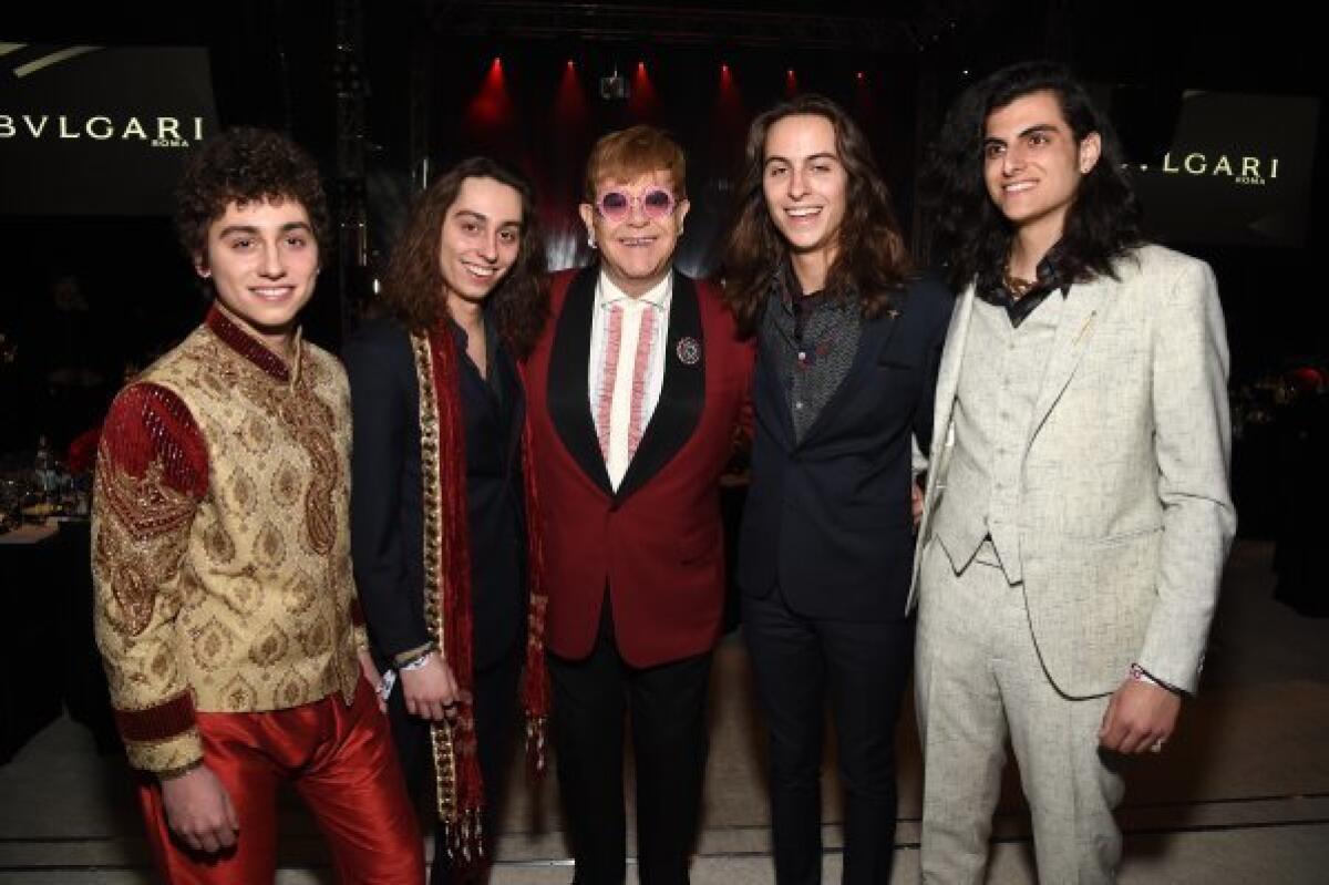 Elton John, center, and members of hard-rock band Greta Van Fleet at his AIDS Foundation dinner and concert on Sunday.