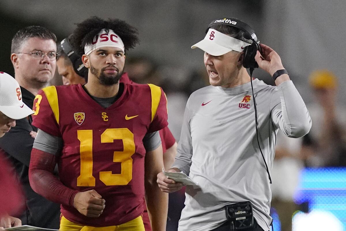 USC quarterback Caleb Williams, left, talks with coach Lincoln Riley during a win over Arizona State on Oct. 1.
