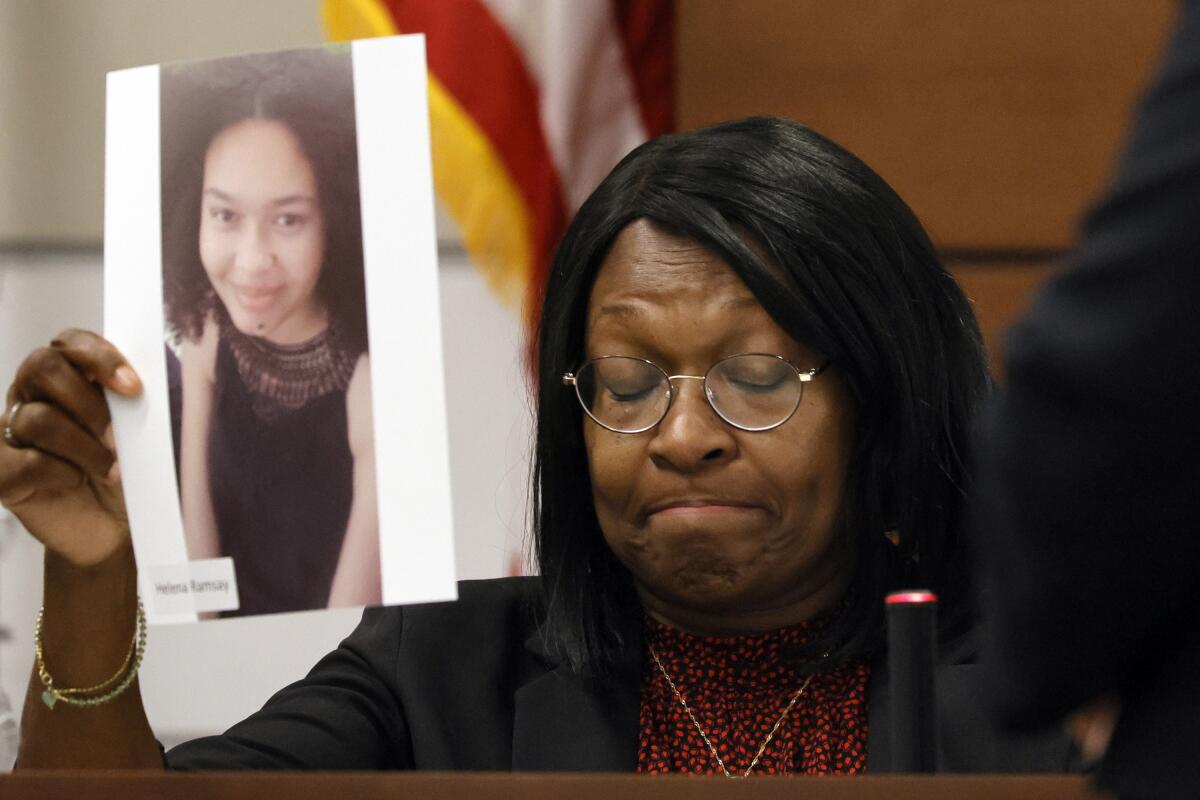 Anne Ramsay holds a picture of her daughter, Helena, before giving her victim impact statement during the penalty phase of the trial of Marjory Stoneman Douglas High School shooter Nikolas Cruz at the Broward County Courthouse in Fort Lauderdale on Thursday, Aug. 4, 2022. Helena was killed in the 2018 shootings. Cruz previously plead guilty to all 17 counts of premeditated murder and 17 counts of attempted murder in the 2018 shootings. (Amy Beth Bennett/South Florida Sun Sentinel via AP, Pool)