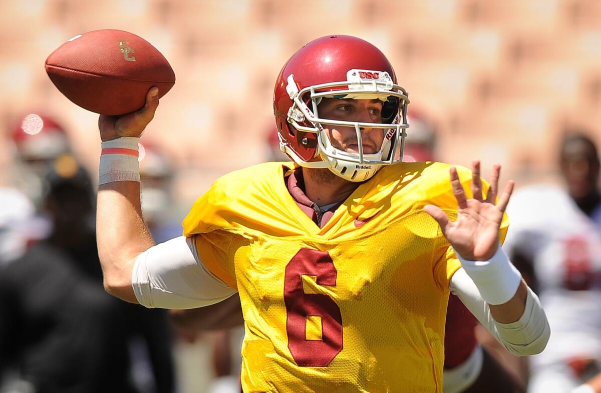 USC quarterback Cody Kessler makes a pass during a team practice session at the Coliseum on Aug. 8.