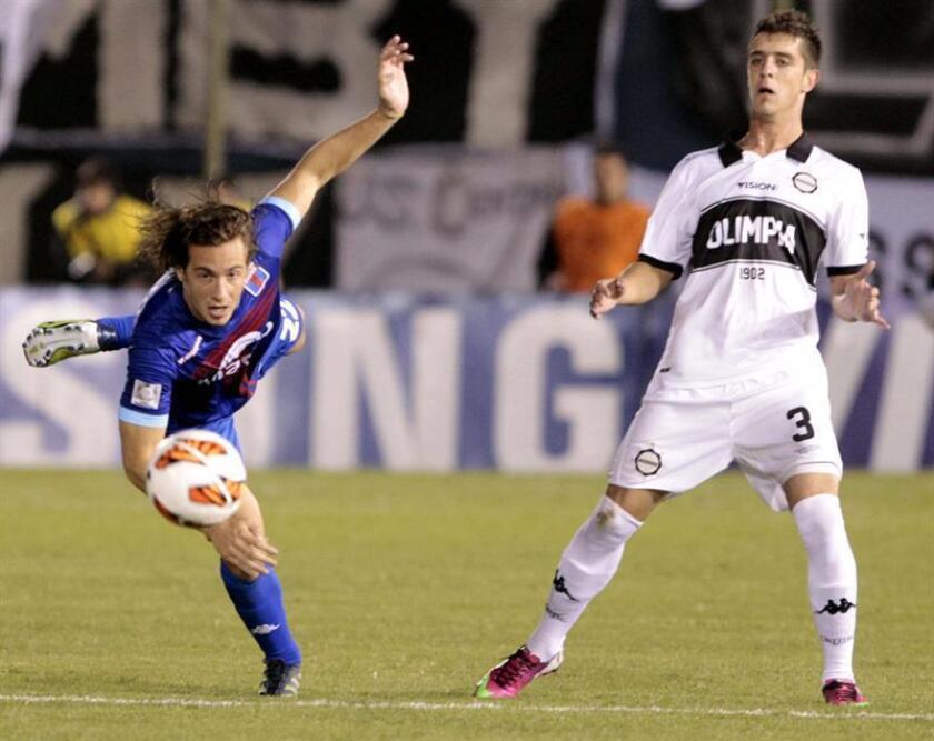 Uruguayan foward Alejandro Silva (R) of Olimpia fights for the ball with Lucas Alfonso Orban (L) of Tigre de Argentina, during a match on Thursday, May 16, 2013, at the Defensores del Chaco stadium in Asunción, Paraguay. EPA-EFE/Andres Cristaldo/FILE