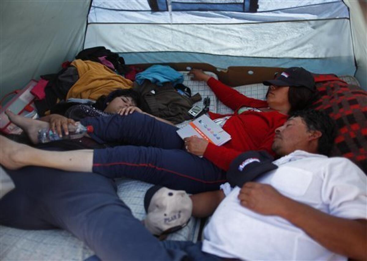 Relatives of trapped miner Dario Segovia sleeps at their tent at the relatives camp at the San Jose Mine near Copiapo, Chile Tuesday, Oct. 12, 2010. Andres Sougarett, the Chilean engineer leading the rescue effort, said all would be in place at midnight Tuesday to begin the rescue of the 33 trapped miners. (AP Photo/Natacha Pisarenko)