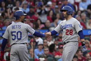 Dodgers' J.D. Martinez, right, is congratulated by Mookie Betts after hitting a home run on May 20, 2023, in St. Louis.