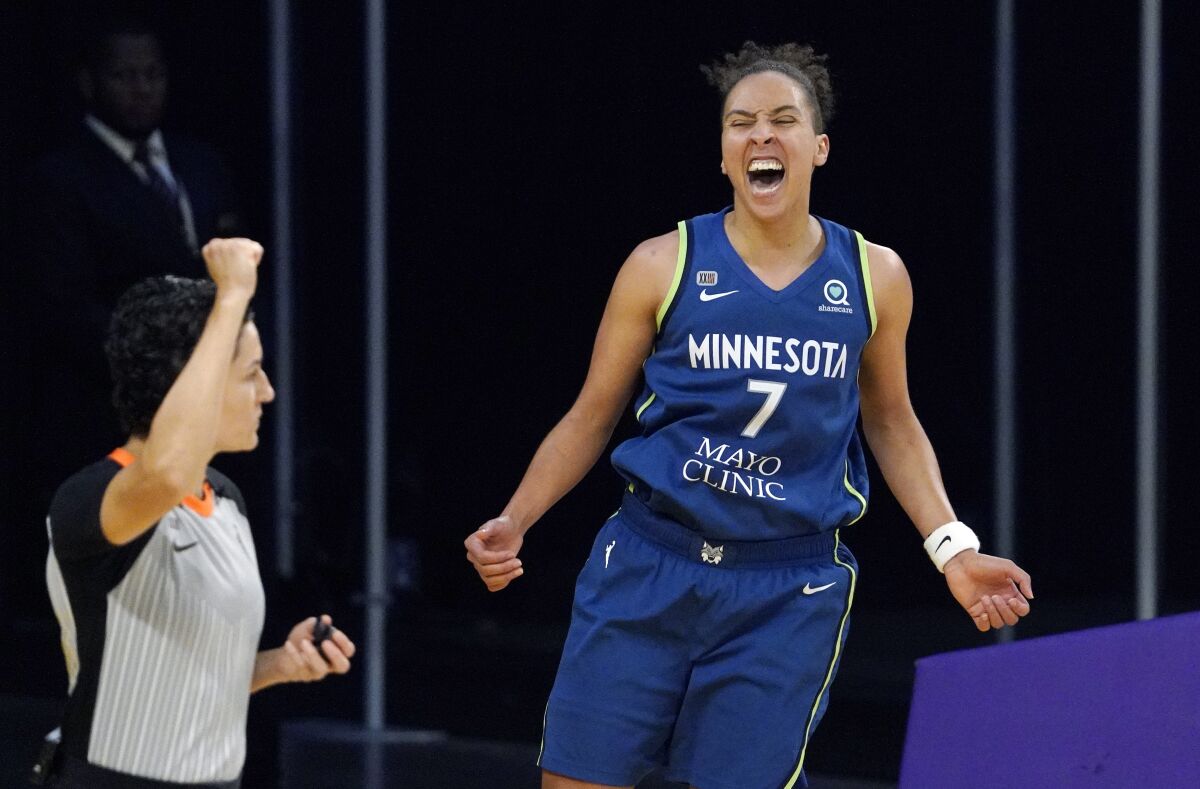 Minnesota Lynx guard Layshia Clarendon, right, celebrates after scoring and drawing a foul during the second half of a WNBA basketball game against the Los Angeles Sparks Sunday, July 11, 2021, in Los Angeles. The Lynx won 86-61. (AP Photo/Mark J. Terrill)