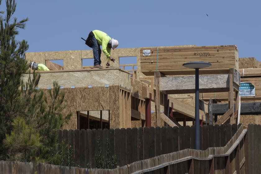 Irvine, CA - August 09: A worker constructs a new home in The Great Park Neighborhoods in Irvine on Monday, Aug. 9, 2021. (Allen J. Schaben / Los Angeles Times)