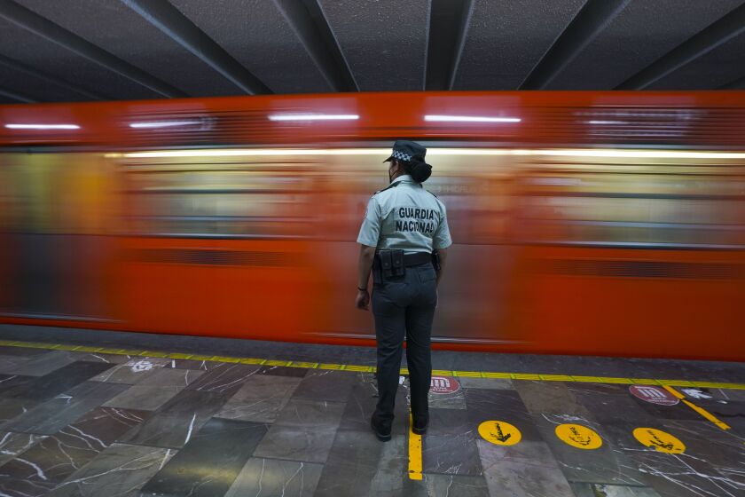 A member of the Mexican National Guard stands guard at a city's subway station in Mexico City, Thursday, Jan. 12, 2023. The mayor of Mexico City says that more the 6 thousand National Guard officers will be posted in the city's subway system after a series of accidents that officials say could be due to sabotage. (AP Photo/Fernando Llano)