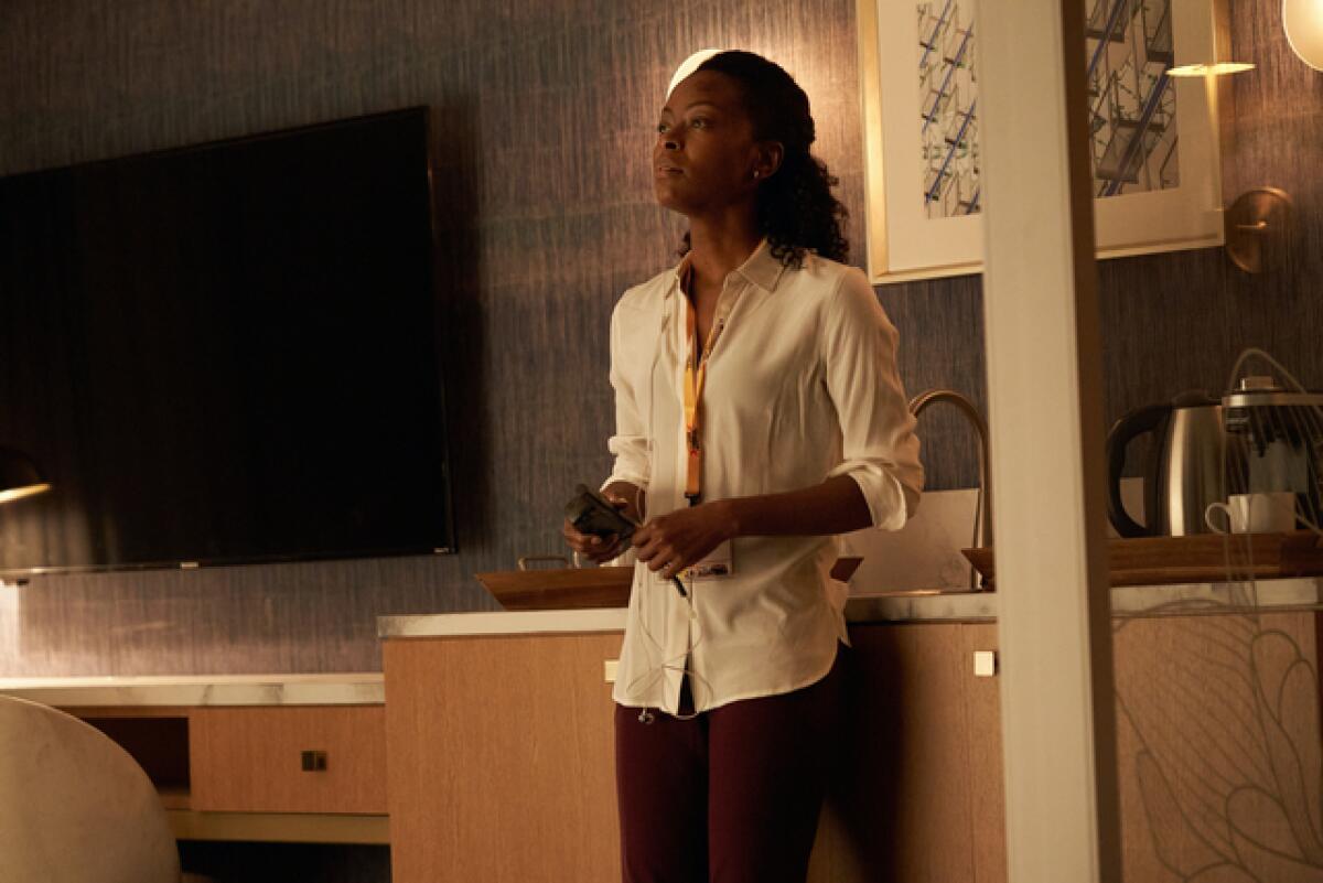 A woman standing in a hotel room