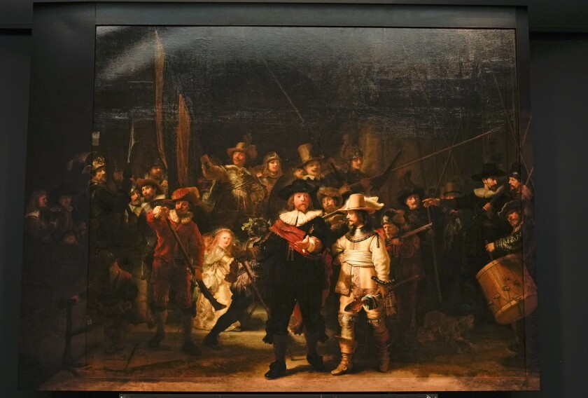 FILE - View of Rembrandt's biggest painting the Night Watch which just got bigger with the help of artificial intelligence, see added sides, in Amsterdam, Netherlands, Wednesday, June 23, 2021. The Netherlands' national museum is planning to re-stretch Rembrandt van Rijn's huge painting "The Night Watch," to get rid of deformations in its top left corner, the Rijksmuseum announced Wednesday, Dec. 8, 2021. (AP Photo/Peter Dejong, File)