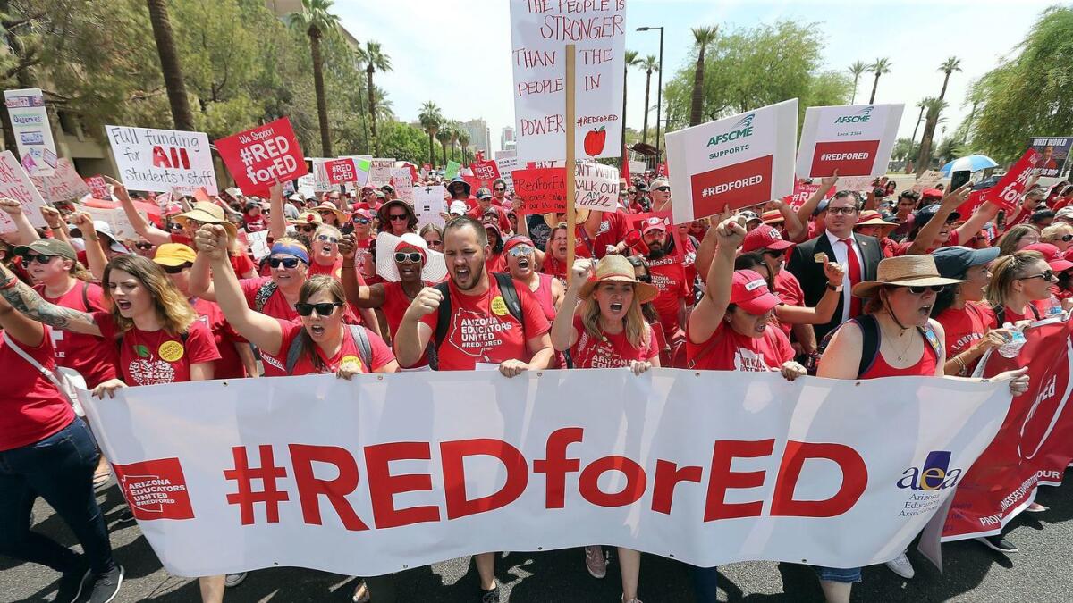 Thousands of Arizona teachers march through downtown Phoenix on their way to the State Capitol.
