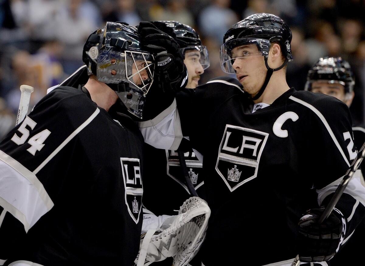 Kings goalie Ben Scrivens is congratulated by team captain Dustin Brown following a win over the Tampa Bay Lightning on Tuesday. Scrivens has performed well since taking over for injured starting goalie Jonathan Quick.