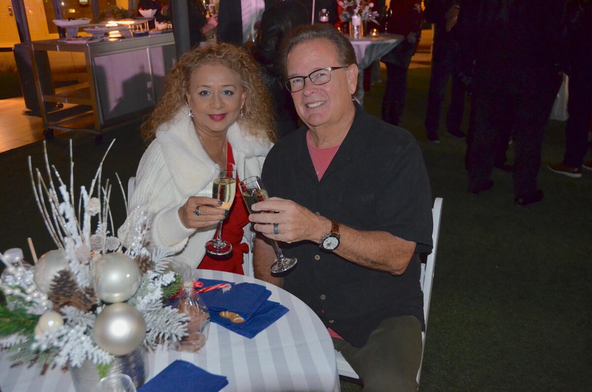 Cheri and Scott Wallace toast with champagne Thursday at the VEA Newport Beach Marriott.