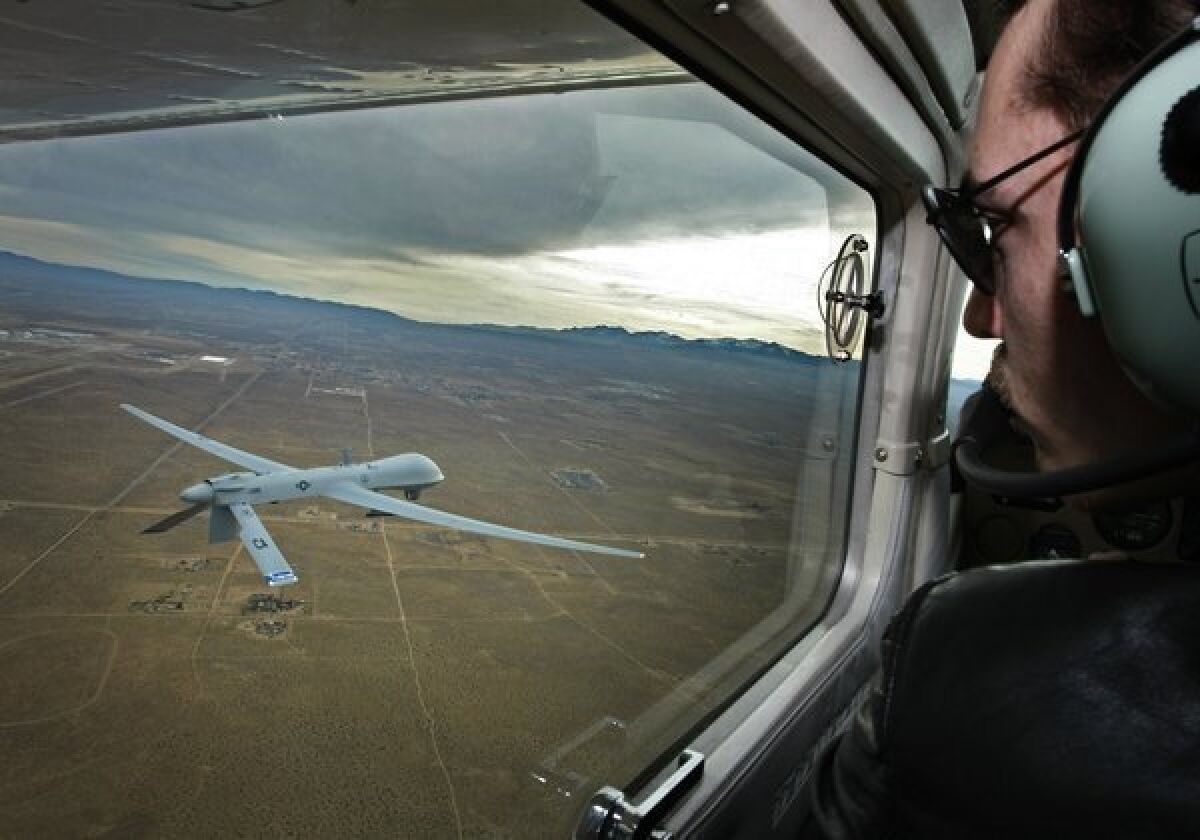 Pilot Mark Bernhardt keeps an eye on a Predator unmanned drone from his chase plane as they fly over Victorville.