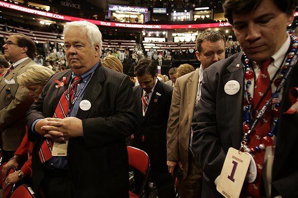 Delegates from Louisiana pray at the closing of the first day of the Republican National Convention in St. Paul, Minn.