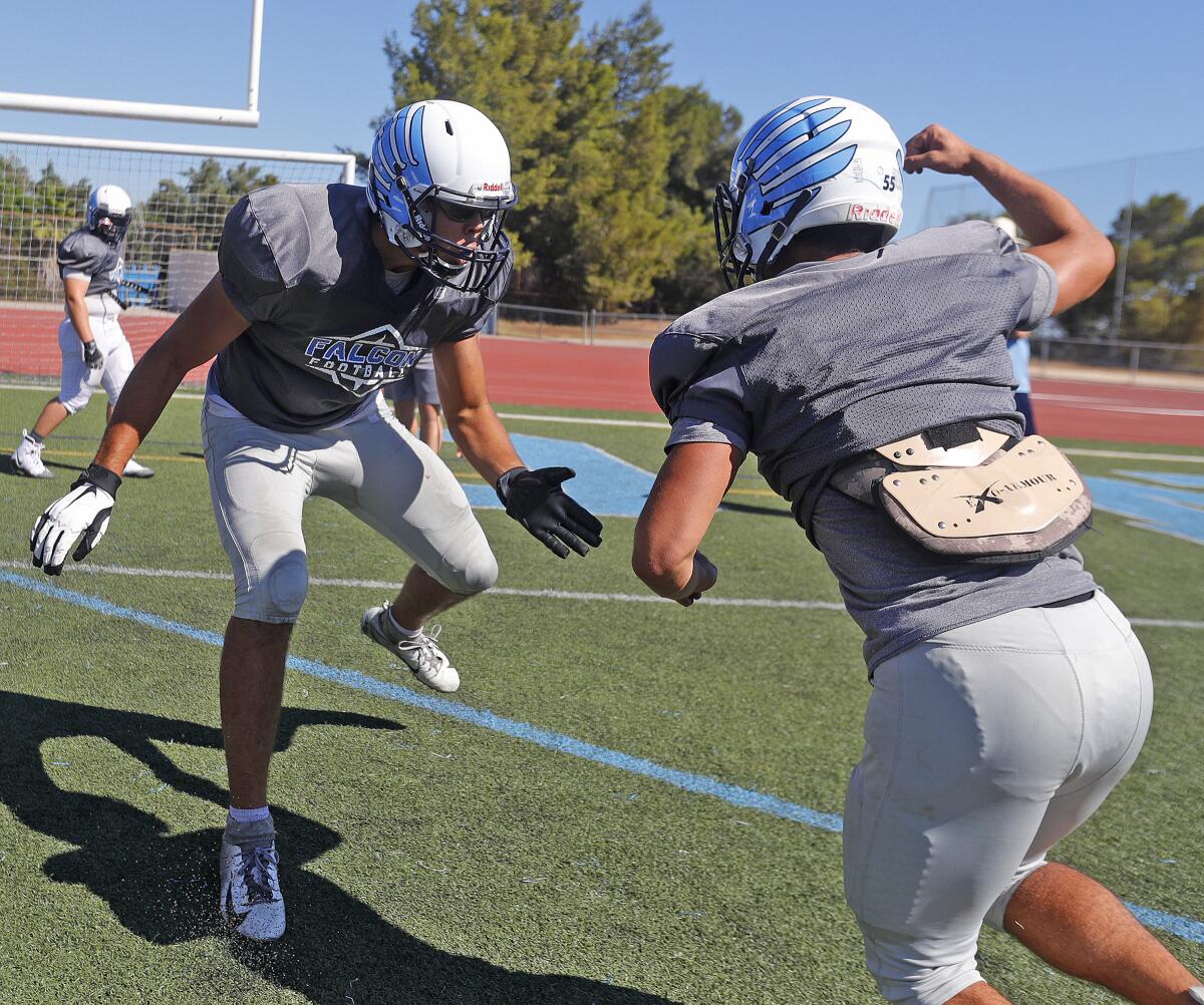 Crescenta Valley offensive lineman Chuck Meyer prepares to block teammate Shant Madatayan during a blocking drill at a preseason football practice at Crescenta Valley High School on Thursday, August 15, 2019.