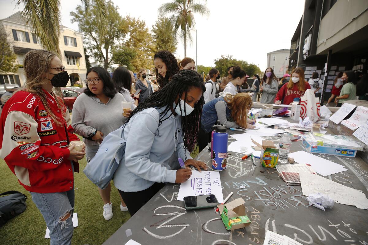 USC junior student Paige Hewlett makes a sign to attach to the Sigma Nu fraternity house near the USC campus on Oct 22.