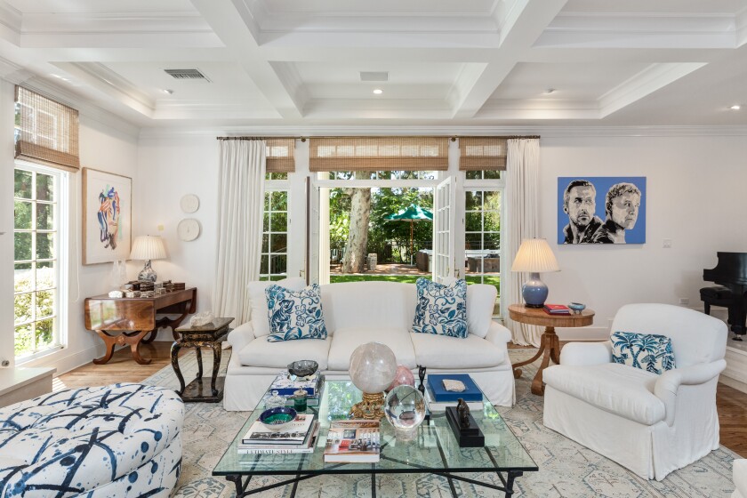 Coffered ceilings, hardwood floors and French doors are among features of the traditional-style house.