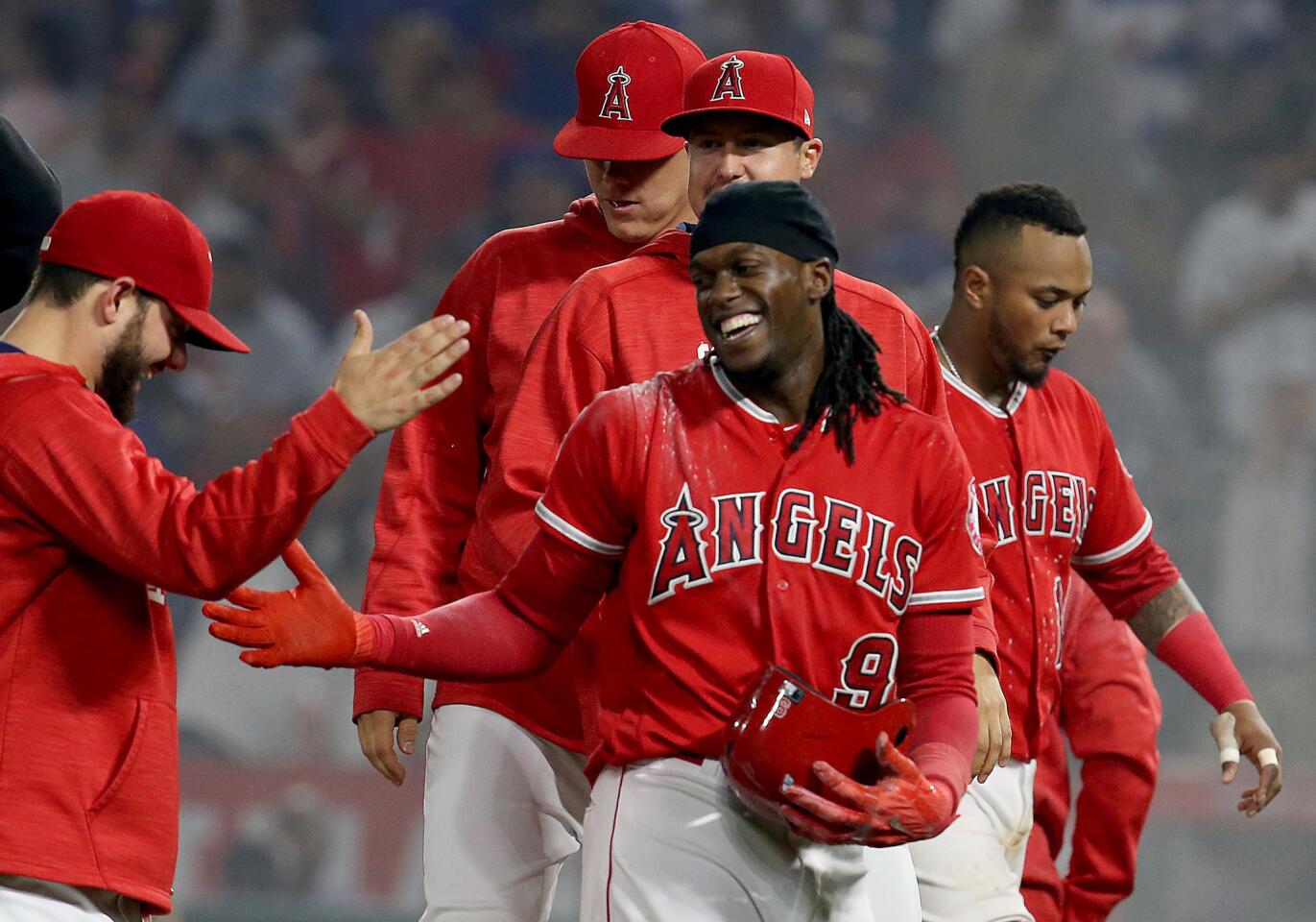 Teammates congratulate Angels center fielder Cameron Maybin after his walk-off strikeout gave the Angels a 3-2 victory over the Dodgerson June 28.