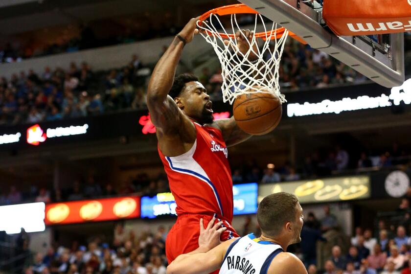 Clippers center DeAndre Jordan finishes off a dunk against the Mavericks on March 13. Which uniform will he be wearing next season?