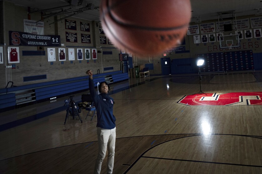 Johnuel "Boogie" Fland shoots hoops in the gymnasium of Archbishop Stepinac High School in White Plains, N.Y., Monday, May 2, 2022. Fland is among a growing number of high school athletes who have signed sponsorship deals for their name, image and likeness following a Supreme Court decision last year that allowed similar deals for college athletes. (AP Photo/Robert Bumsted)