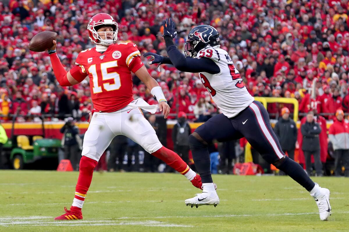 Kansas City Chiefs quarterback Patrick Mahomes scrambles under pressure from Houston's Whitney Mercilus during an AFC playoff game Jan. 12 at Arrowhead Stadium.