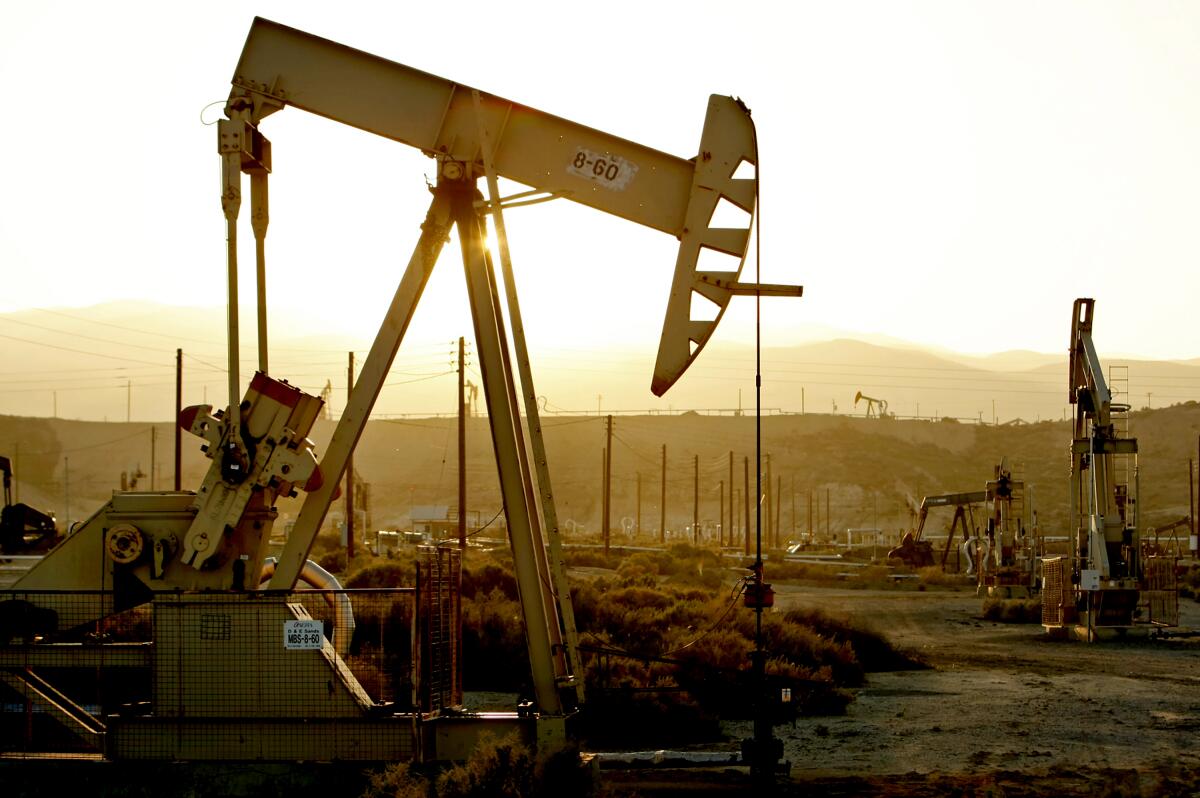 Oil rig pump jacks in an oil field.