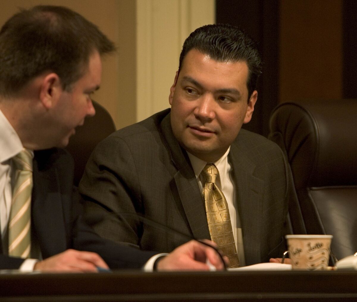 State Sen. Alex Padilla (D-Pacoima), right, listens to a staffer during a Senate committee hearing.