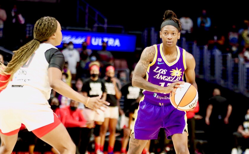 Sparks point guard Erica Wheeler is defended by Atlanta guard Odyssey Sims.