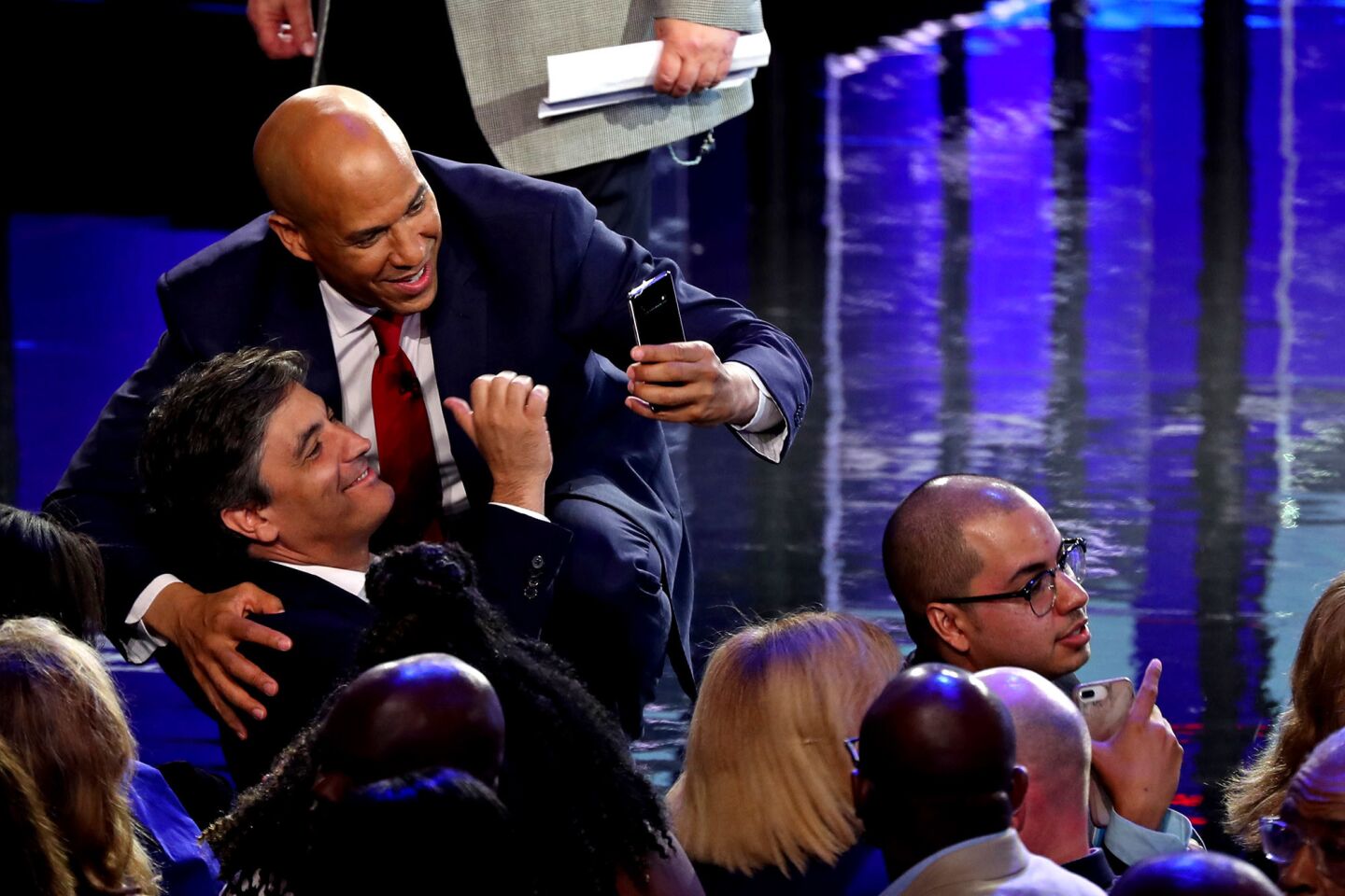 Sen. Cory Booker (D-NJ) greets a member of the audience after the first night of the Democratic presidential debate on June 26, 2019 in Miami, Florida. A field of 20 Democratic presidential candidates was split into two groups of 10 for the first debate of the 2020 election, taking place over two nights at Knight Concert Hall of the Adrienne Arsht Center for the Performing Arts of Miami-Dade County, hosted by NBC News, MSNBC, and Telemundo.