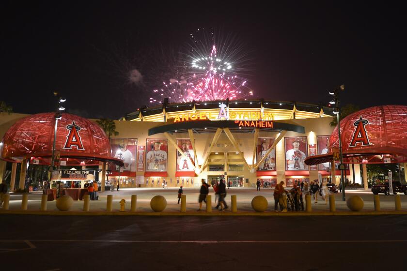 Fireworks light up the night sky behind the entrance to Angel Stadium following a game against the Chicago White Sox in May 2013. The Angels have expressed frustration over negotiations with the Anaheim City Council regarding a proposed stadium lease agreement.