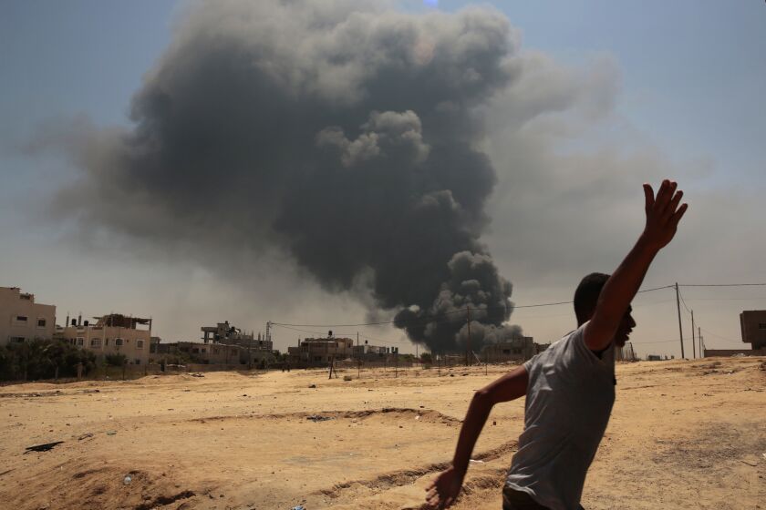 After a night of heavy bombardment by Israeli forces, smoke rises from a power plant outside the town of Bureij in the Gaza Strip on July 29, 2014.